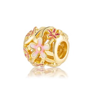 May include: A gold-toned charm bead featuring an openwork design with multiple five-petaled flowers. The flowers are accented with light pink and dark pink enamel detailing. The bead has a central hole for threading onto a bracelet or necklace chain.