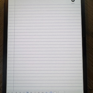 May include: A digital tablet displaying a lined notebook page with the text "Green Single Subject Notebook". The screen shows a time stamp and battery life indicator. A decorative scroll design is at the top.