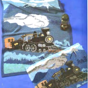 May include: Two blue and white crocheted rugs with a train design. The rugs feature a black train with white smoke and a mountain scene.