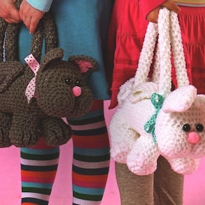 May include: Two crocheted animal purses. One is a brown dog with pink ears and a pink and white polka dot bow. The other is a white bunny with green and white polka dot bow.