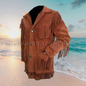 May include: A brown suede jacket with fringe detailing on the chest, sleeves, and pockets. The jacket has a button-up front and a collar. The background shows a beach scene with the text "BalalaamazingShop".
