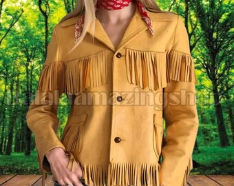 May include: Mustard yellow suede jacket with fringe detailing. The jacket has a collared neckline, button closure, and two front pockets. The fringe is along the sleeves, chest, and bottom hem. The jacket is worn with a red bandana.