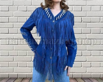 May include: A blue suede jacket with long fringe detailing. The jacket features white stitching along the collar, cuffs, and sleeves. The jacket is buttoned up and worn with blue jeans.