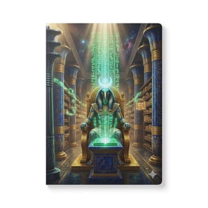 May include: A hardcover journal featuring an illustration of an Egyptian deity seated on a throne in a library. The deity is depicted in shades of green and gold, with hieroglyphs and celestial elements. The journal has a glossy finish.