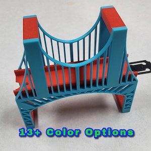 May include: A blue and red plastic bridge toy with a black metal connector. 13+ Color Options.