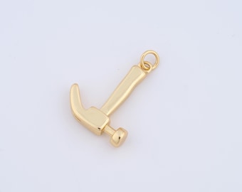 May include: A gold-colored hammer charm with a loop for attaching to a necklace or bracelet.