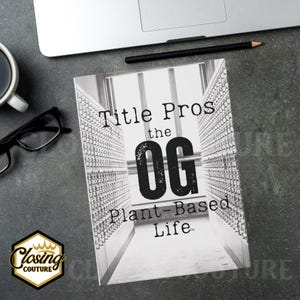 May include: A grayscale book titled "Title Pros the OG Plant-Based Life" with a black and gold logo in the lower left corner. The book is on a gray surface with a laptop, pencil, glasses, and a cup of coffee.