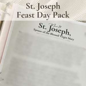May include: A white binder with the text "St. Joseph Feast Day Pack" and "St. Joseph, Spouse of the Blessed Virgin Mary." The binder is open, revealing pages with blurred text. The Grace & Hearth Co. logo is visible.