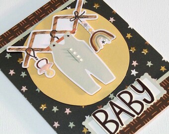 Handmade Baby Congratulations Card - BoHo Theme Features a Wooden Clothes Rack, a Jumper, a Rainbow Mobile, a Pacifier & Chipboard BABY Word