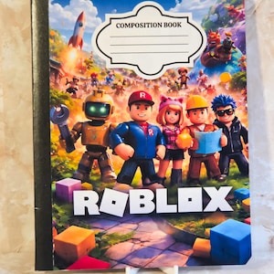 May include: A Roblox composition book featuring a colourful cover with a group of five cartoon characters, a rocket, and various blocks. The top of the cover has a white label with the text COMPOSITION BOOK and the word ROBLOX printed at the bottom.