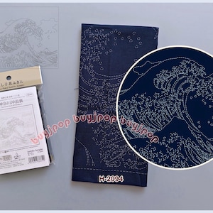 May include: Navy blue fabric with white wave embroidery, a circular detail, and a packaged sampler featuring the same design. The sampler includes Japanese text and a barcode. The fabric has the code H-2094.