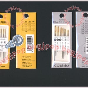 May include: Four packages of sewing needles, each with a different brand and size. The packages are yellow, white, and silver. The needles are arranged in rows and are all the same size. The packages are labeled with the brand name, size, and country of origin. The text on the packages is in Japanese.