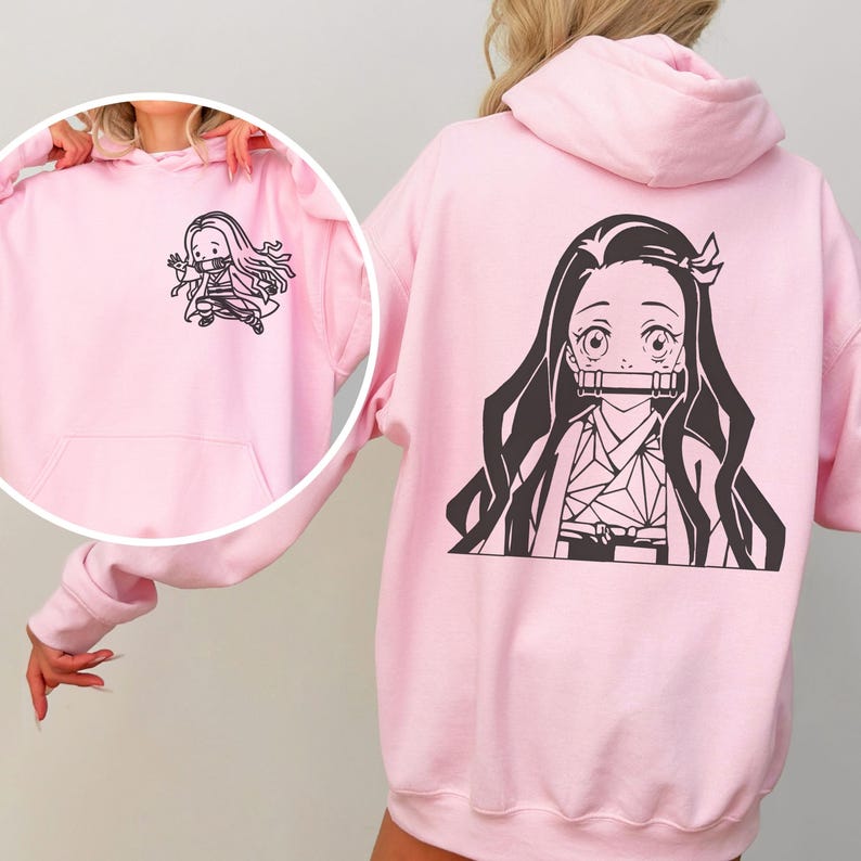 May include: A light pink hooded sweatshirt featuring a large black graphic print of an anime character with long hair and a bamboo muzzle on the back, and a smaller matching graphic print of the same character on the front left chest area.
