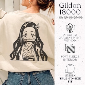 May include: A beige crewneck sweatshirt featuring a dark brown graphic of an anime character with long hair and a bamboo muzzle. The right side displays text: Gildan 18000, Direct to Garment Print Method, Soft Fleece Interior, and Unisex True-to-Size Fit.