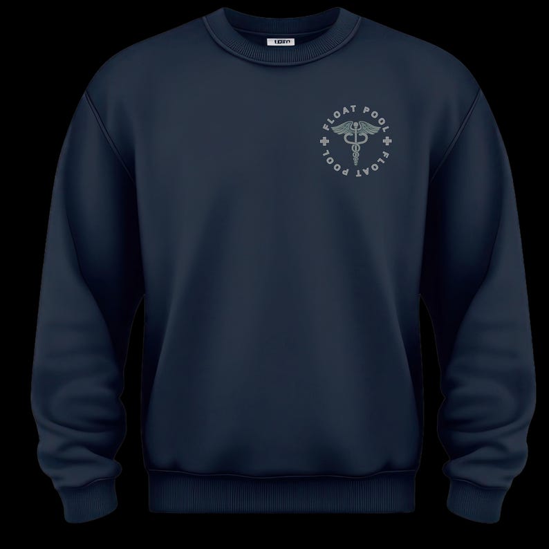 May include: A navy blue crewneck sweatshirt featuring a circular graphic on the upper left chest. The design includes the text FLOAT POOL surrounding a caduceus symbol with wings and snakes, accented by small crosses on the left and right sides.