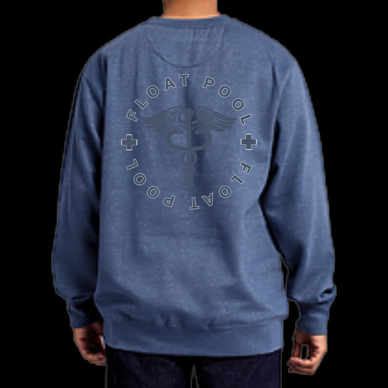 May include: A blue heathered long-sleeve sweatshirt featuring a circular graphic on the back. The design includes the text FLOAT POOL repeated in a circle, two small crosses, and a central caduceus symbol in a dark, muted tone.