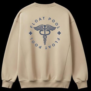May include: A beige crewneck sweatshirt featuring a dark blue graphic on the back. The design includes a central caduceus symbol enclosed in a circle with the text FLOAT POOL and two small cross icons positioned on the left and right sides.