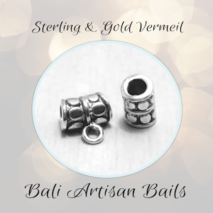 May include: Two silver-toned metal bail charms with a textured, circular design. The charms are made in Bali and are suitable for jewelry making.