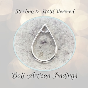 May include: A silver-colored teardrop-shaped jewelry finding. The open-backed pendant has a loop at the top and a rounded bottom. The text "Sterling & Gold Vermeil" and "Bali Artisan Findings" are also in the image.