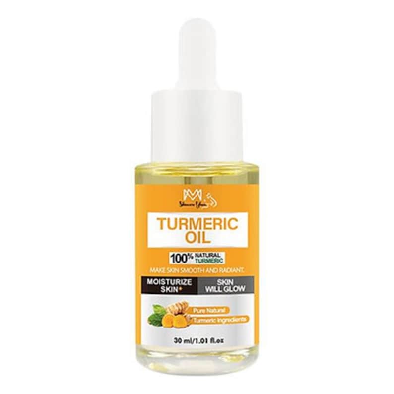 Golden turmeric facial oil in a clear glass dropper bottle. This natural skin brightening serum is designed for a glowing complexion and targeted scar reduction on the face and body.