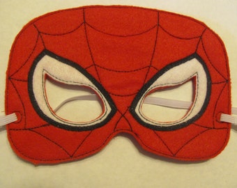 May include: Red felt Spider-Man mask with black web design and white eye holes. The mask has elastic straps for wearing.