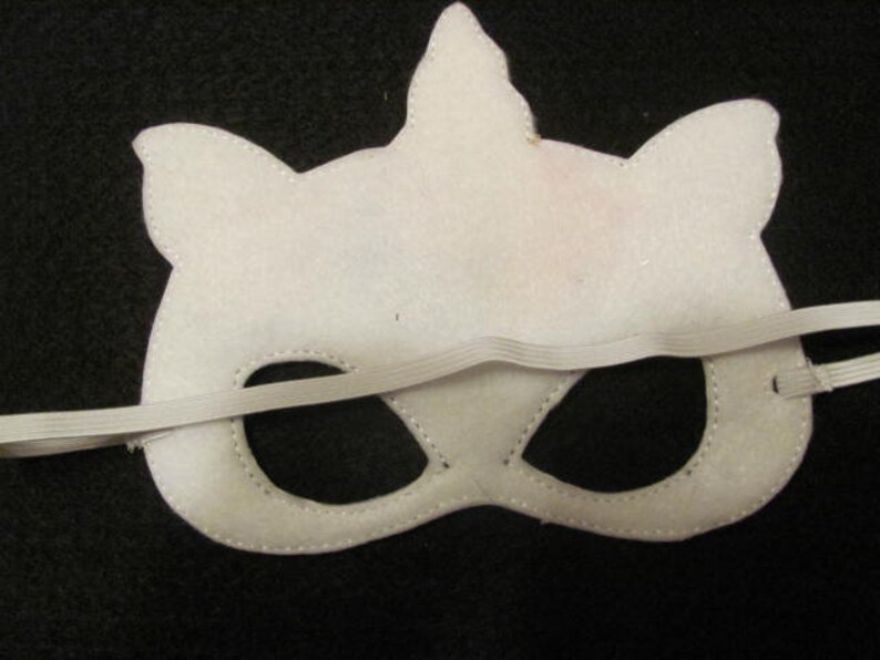 May include: White felt unicorn mask with black eye holes and an elastic band.
