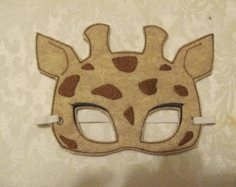 May include: A brown felt giraffe mask with brown spots and white eye holes. The mask has elastic straps attached to the sides.