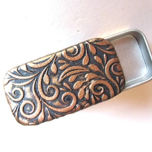 MINI Pill Box in antique gold on black  polymer clay| Swirly vines pattern|  Sturdy slide-top tin| Tiny pill holder| FREE velvet gift pouch