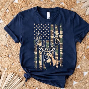 A navy blue t-shirt with a graphic design featuring a deer head and an American flag pattern.