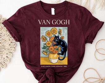 May include: Burgundy t-shirt featuring a graphic of Van Gogh's "Sunflowers" with a black cat. The design includes the text "VAN GOGH" above the image and "SUNFLOWERS (THIRD VERSION) - 1888" below it.