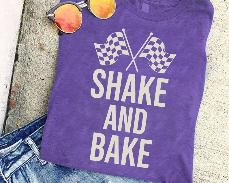 A purple t-shirt with the text "SHAKE AND BAKER" printed on it, along with a pair of sunglasses and a pair of jeans.