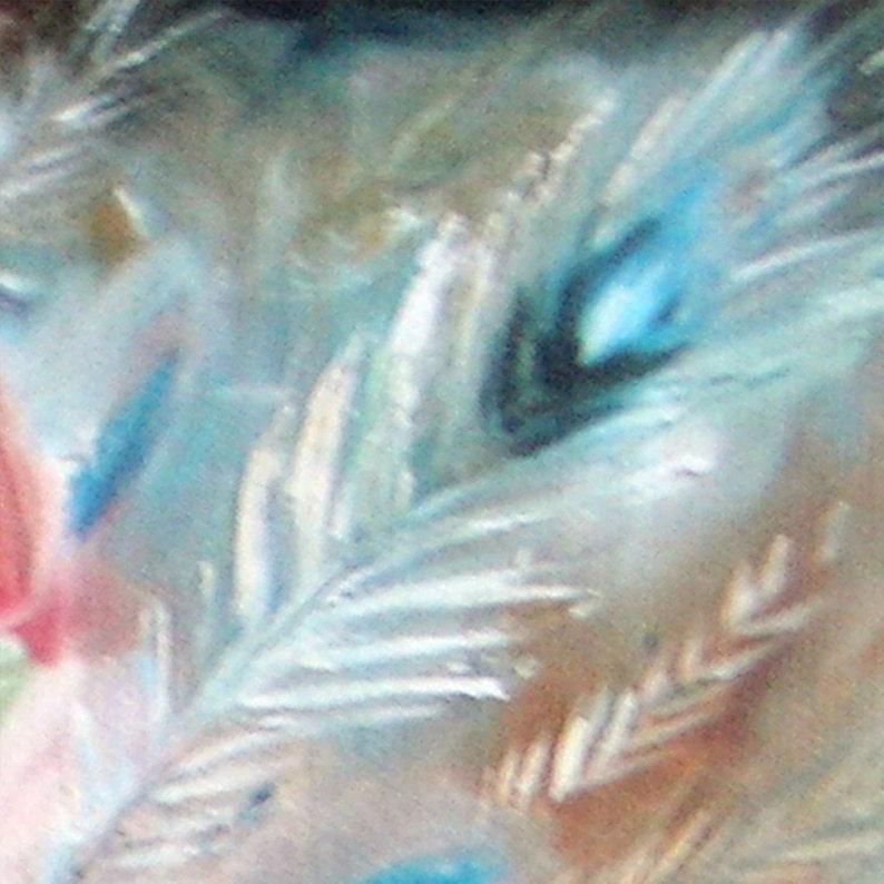 May include: Close-up of a blue and white peacock feather with a soft, feathery texture. The feather has a dark blue eye and white tips.
