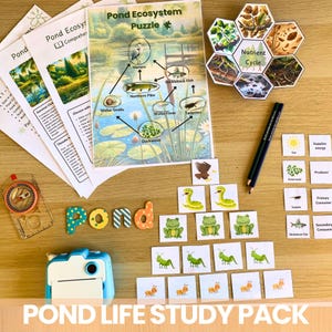 May include: A colorful pond ecosystem study pack with a variety of learning materials, including a puzzle, flashcards, and a nutrient cycle diagram. The pack also includes a compass, pencils, and a small camera.