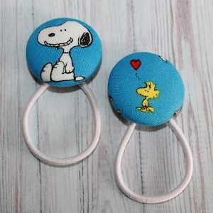 For the ultimate Charlie Brown fan...Snoopy and Woodstock pony tail holders!