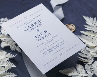 May include: A white wedding invitation with blue text. The invitation reads "You are invited to celebrate the wedding of Carrie Samson & Jack Porter. Saturday, April 26, 2025 at 6:00 PM. Westwood Country Club, Hilton Head, South Carolina. Reception to follow."
