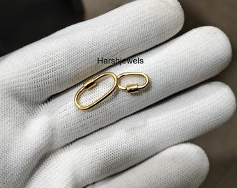 May include: Two gold-colored oval-shaped clasps with screw closures. The clasps are displayed on a white surface. The text "Harshjewels" is visible in the upper left corner.