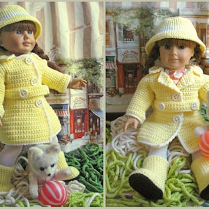 May include: A doll wearing a handmade yellow crochet outfit, including a coat, skirt, hat, and boots. The outfit is trimmed with white and features white buttons. A small stuffed bear and a striped ball are also present.