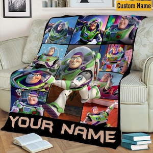 May include: A fleece blanket featuring a collage of Buzz Lightyear from Toy Story in various poses and expressions. The design includes a large central image of the character and the text YOUR NAME in bold, black, capital letters at the bottom.