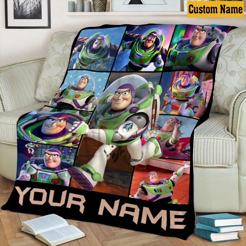 May include: A fleece blanket featuring a collage of Buzz Lightyear from Toy Story in various poses and expressions. The design includes a large central image of the character and the text YOUR NAME in bold, black, capital letters at the bottom.