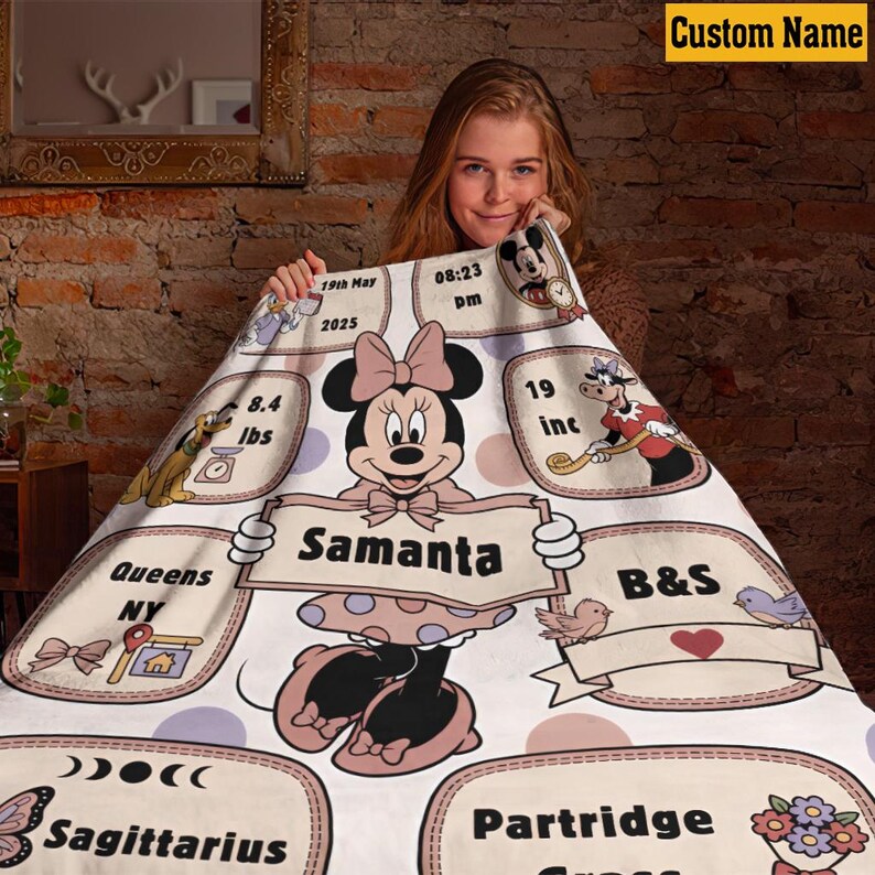 May include: A personalized Minnie Mouse blanket with the name "Samanta" displayed prominently. The blanket features Minnie Mouse, along with details like weight (8.4 lbs), length (19 inches), and birth date. Additional text includes "Queens NY" and "B&S".