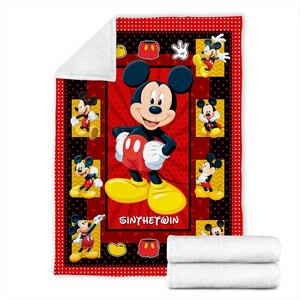 May include: A red and black Mickey Mouse themed blanket. The blanket features a large image of Mickey Mouse in the center, surrounded by smaller images of Mickey. The border is red with black polka dots. The blanket is folded with two white blankets.