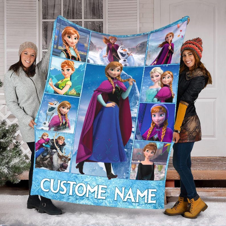 May include: A custom blanket featuring images of the animated character Anna from the movie Frozen. The blanket has a blue background with multiple images of Anna in various poses. The words "CUSTOM NAME" are printed at the bottom.