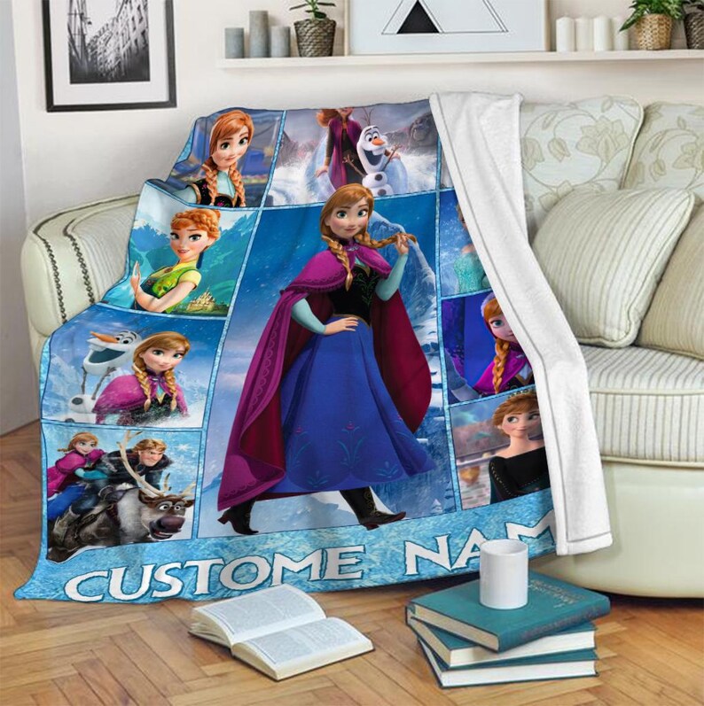 May include: A blue fleece throw blanket featuring images of a princess in a blue dress and a purple cape. The blanket has a collage design with the text "CUSTOM NAME" at the bottom.