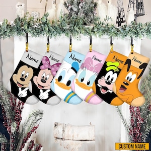 May include: Six Christmas stockings featuring Disney characters Mickey Mouse, Minnie Mouse, Donald Duck, Daisy Duck, Goofy, and Pluto. Each stocking is a different color and has the word "Name" printed on it. The bottom right corner of the image has the words "Custom Name".