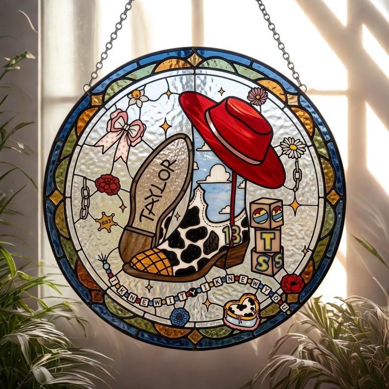May include: A circular stained glass suncatcher featuring a cow-print cowboy boot with the number 13, a red hat, a pink bow, and blocks spelling TSS. The text TAYLOR is on the boot sole, and the phrase I KNEW IT I KNEW YOU is on a beaded string.