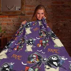 May include: A purple fleece blanket featuring a repeating pattern of The Nightmare Before Christmas characters, including Jack Skellington, Sally, and Oogie Boogie, interspersed with black bows, spiderwebs, bats, and the customizable text NAME.
