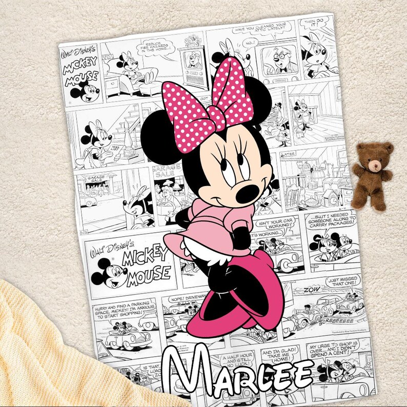May include: A pink Minnie Mouse blanket featuring a comic strip design with black and white panels and the text "Walt Disney's Mickey Mouse." Minnie Mouse is in the center, wearing a pink dress and bow. The name "Marlee" is at the bottom.