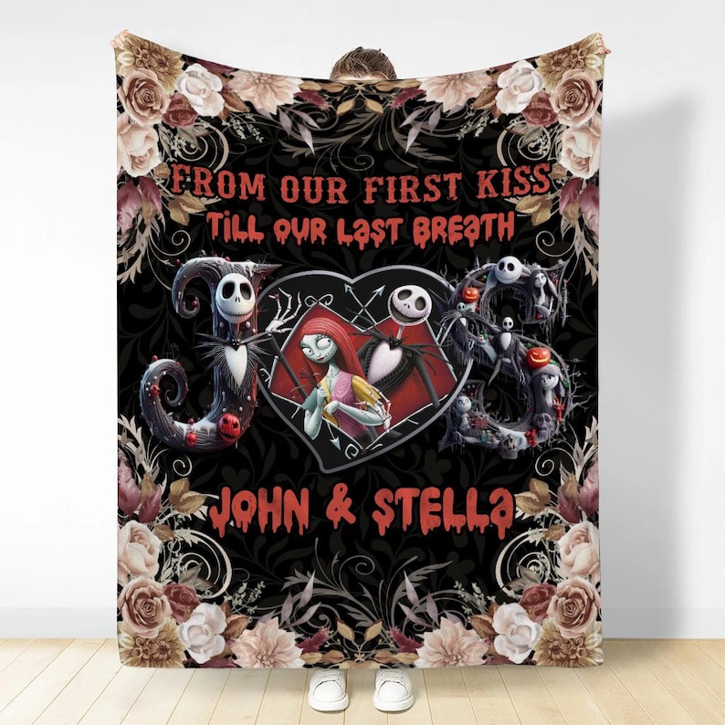 May include: A black throw blanket featuring a floral border and the text FROM OUR FIRST KISS TILL OUR LAST BREATH. It displays a heart containing two animated characters, flanked by large letters J and S, with the names JOHN & STELLA below.