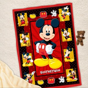 May include: A red and black Mickey Mouse blanket featuring Mickey Mouse in various poses. The blanket has a red border with white polka dots and a central red panel with Mickey Mouse. The text "SINYTHE@IN" is visible.