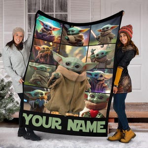 May include: A black blanket featuring a collage of images of a green alien character with large ears and brown robes. The blanket has the text "YOUR NAME" in green letters at the bottom.